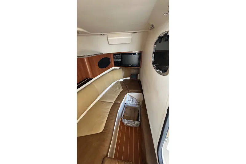  Yacht Photos Pics Interior of 2013 Grady-White Freedom 335 boat, featuring seating and a porthole window.