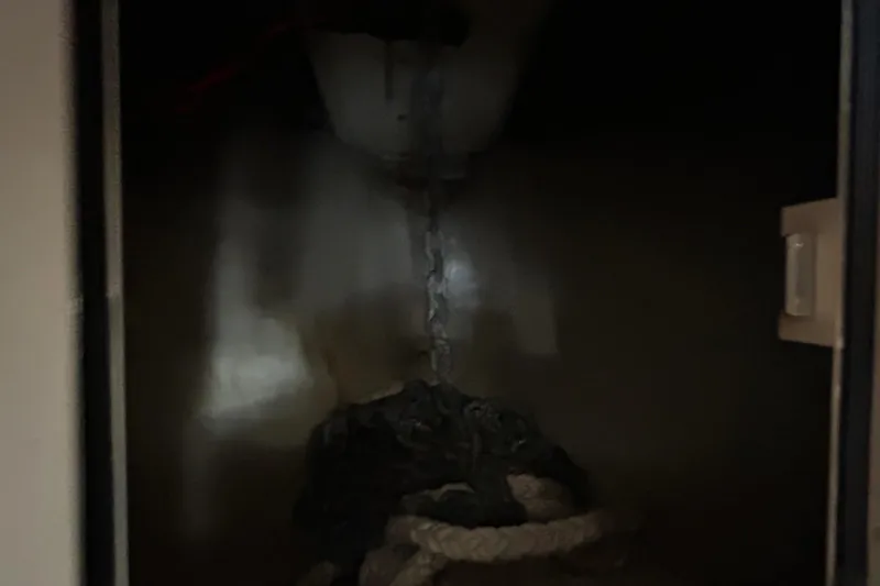  Yacht Photos Pics Dark storage compartment on 2013 Grady-White Freedom 335 boat, containing ropes and chains.