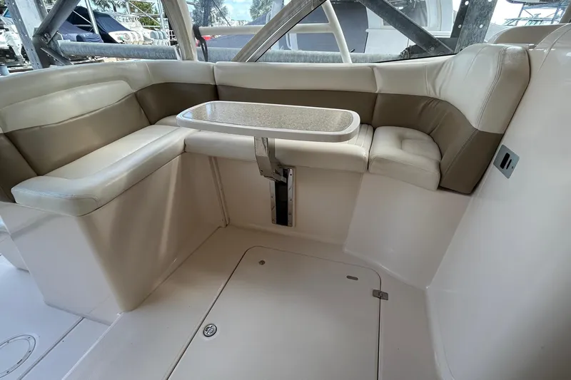  Yacht Photos Pics 2013 Grady-White Freedom 335 boat interior with cushioned seating and table.