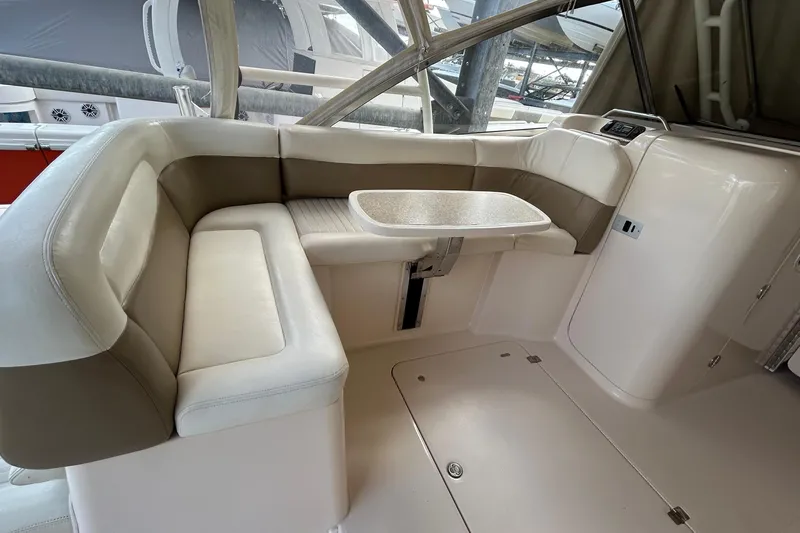  Yacht Photos Pics 2013 Grady-White Freedom 335 boat interior with cushioned seating and table.