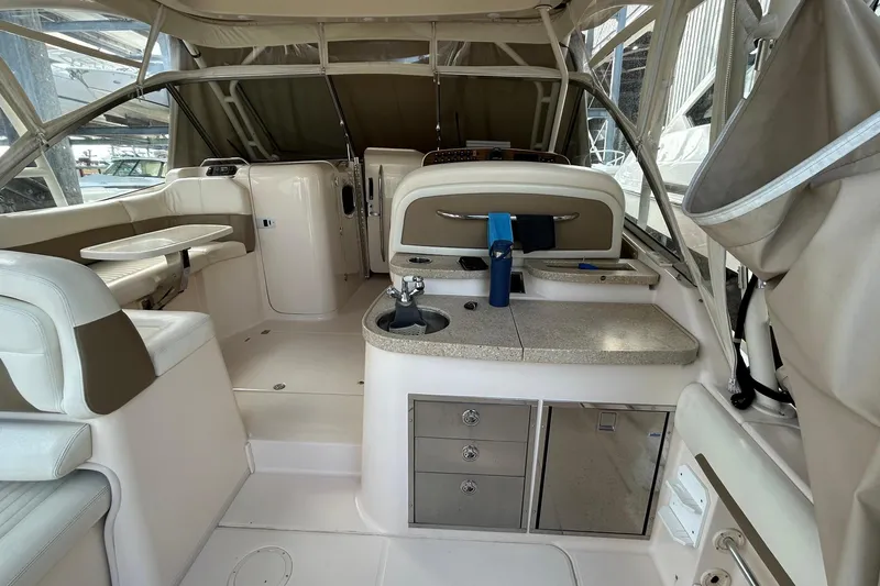  Yacht Photos Pics 2013 Grady-White Freedom 335 boat interior with seating, table, and kitchenette area.