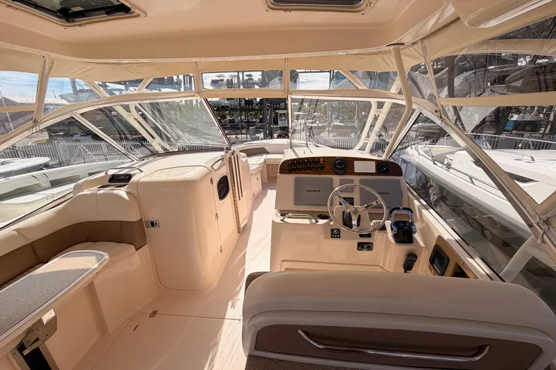  Yacht Photos Pics 2013 Grady-White Freedom 335 boat interior with helm, seating, and navigation equipment.
