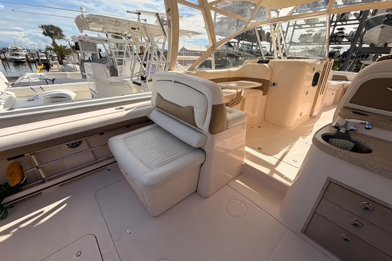  Yacht Photos Pics 2013 Grady-White Freedom 335 boat interior with seating, sink, and helm station.