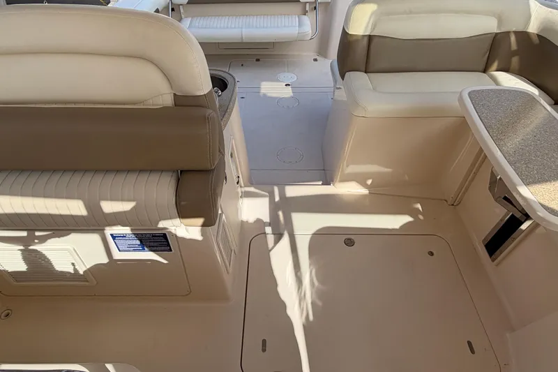  Yacht Photos Pics 2013 Grady-White Freedom 335 boat interior with beige seating and table.