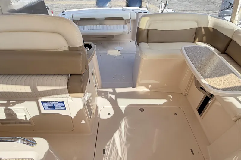  Yacht Photos Pics 2013 Grady-White Freedom 335 boat interior with beige seating and table.