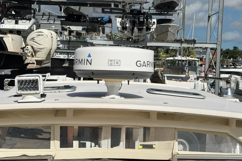  Yacht Photos Pics 2013 Grady-White Freedom 335 boat with Garmin radar, docked in a marina.