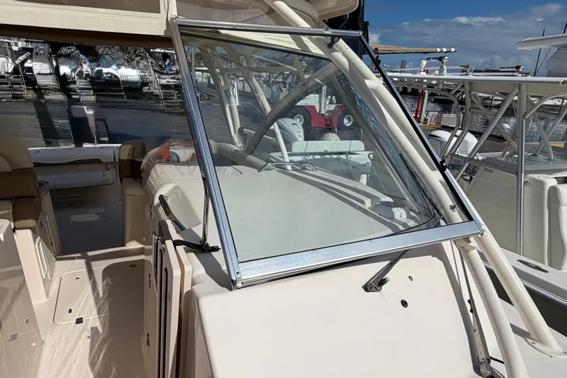  Yacht Photos Pics 2013 Grady-White Freedom 335 boat interior with open cockpit and seating at marina.