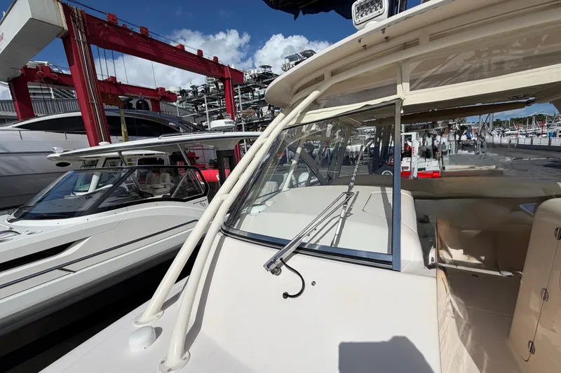  Yacht Photos Pics 2013 Grady-White Freedom 335 boat docked at marina under clear blue sky.
