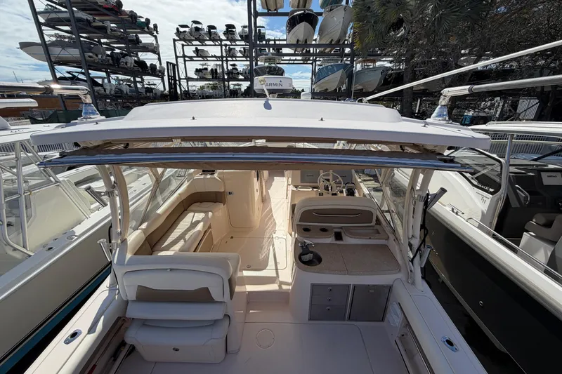  Yacht Photos Pics 2013 Grady-White Freedom 335 boat interior with seating and helm, docked in marina.