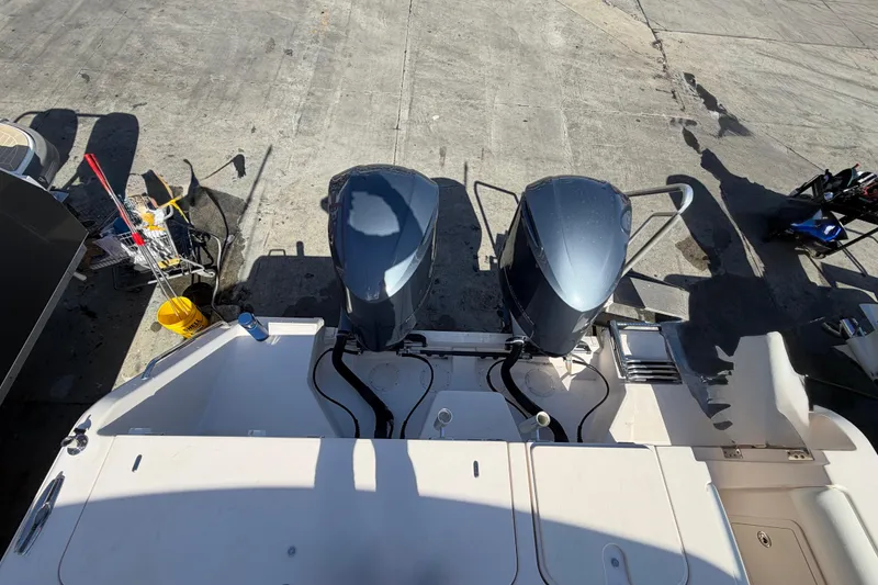  Yacht Photos Pics 2013 Grady-White Freedom 335 boat with dual outboard motors on a concrete surface.