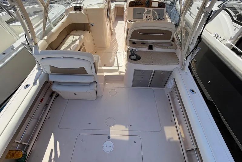  Yacht Photos Pics 2013 Grady-White Freedom 335 boat interior with seating, helm, and kitchenette area.
