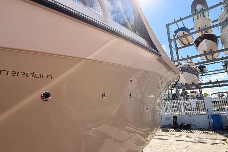  Yacht Photos Pics 2013 Grady-White Freedom 335 boat in storage, sunlit hull detail.