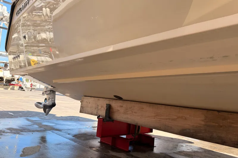  Yacht Photos Pics 2013 Grady-White Freedom 335 boat hull on dry dock, supported by wooden blocks.