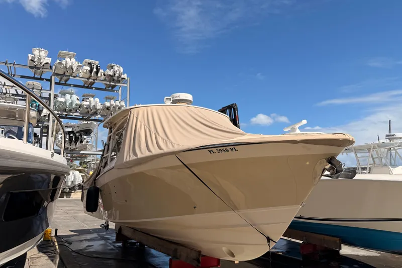  Yacht Photos Pics 2013 Grady-White Freedom 335 boat docked under clear blue sky.