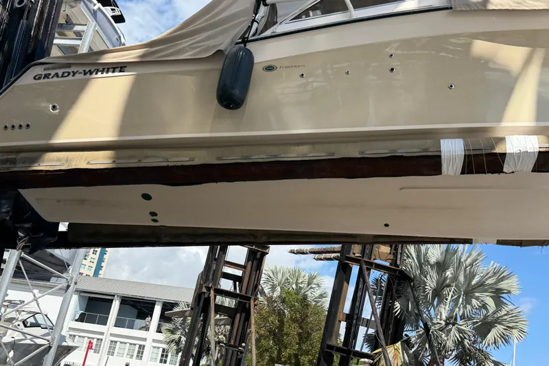  Yacht Photos Pics 2013 Grady-White Freedom 335 boat on lift, showcasing hull and exterior details.