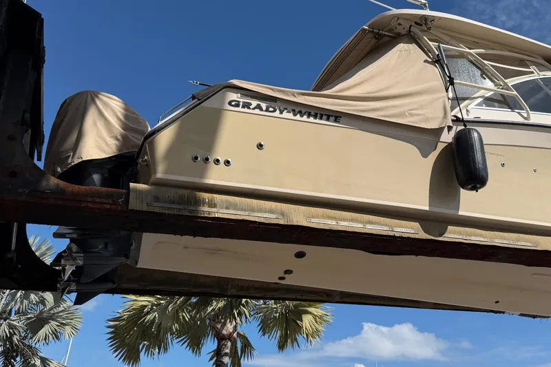  Yacht Photos Pics 2013 Grady-White Freedom 335 boat on lift, clear sky background.