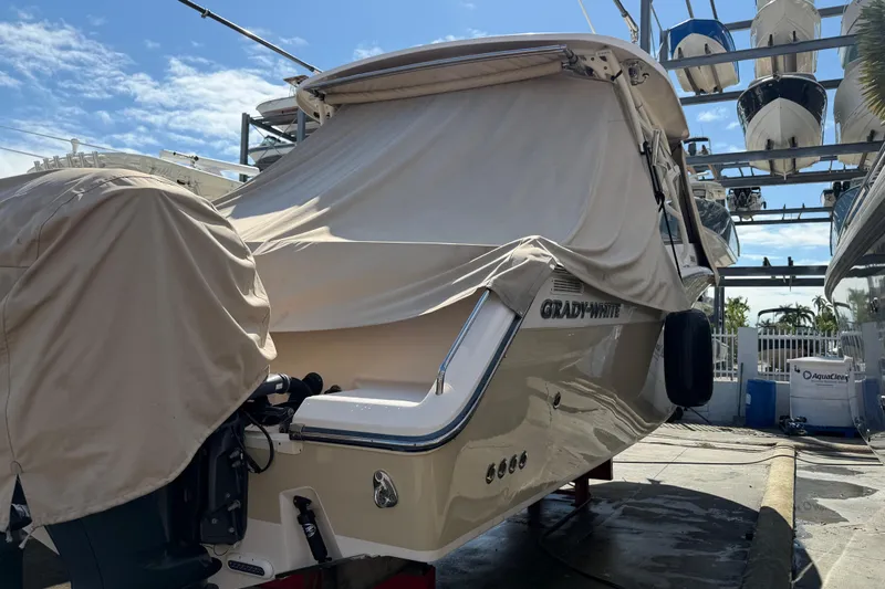  Yacht Photos Pics 2013 Grady-White Freedom 335 boat covered and docked in a marina.