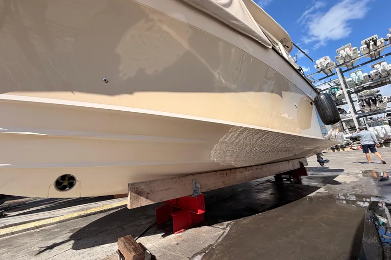  Yacht Photos Pics 2013 Grady-White Freedom 335 boat on dry dock, hull view, sunny day.