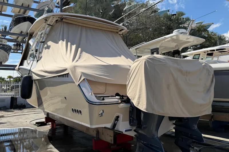 Yacht Photos Pics 2013 Grady-White Freedom 335 boat covered and docked, with outboard motors visible.