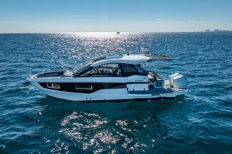  Yacht Photos Pics 2023 Galeon 375 GTO yacht cruising on open sea under clear blue sky.