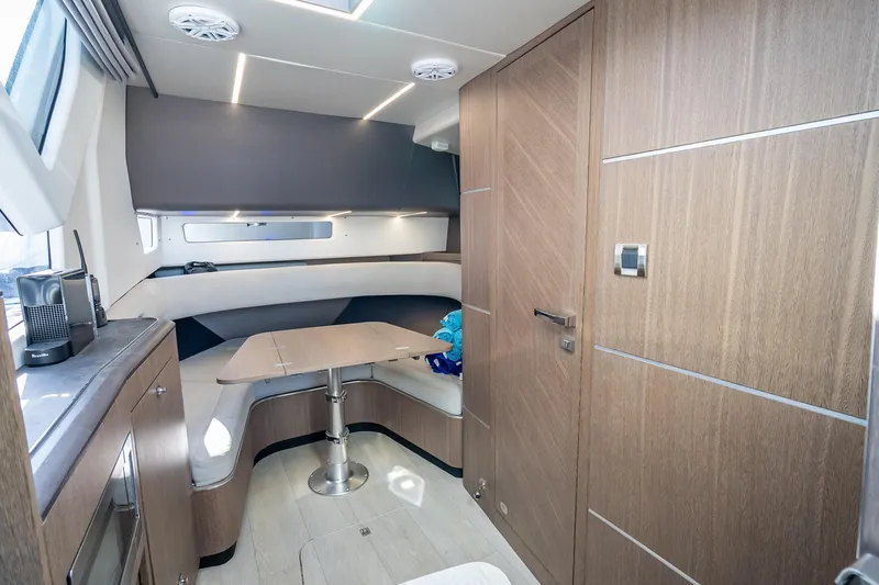  Yacht Photos Pics Interior of 2023 Galeon 375 GTO yacht with modern wood finish and cozy seating area.