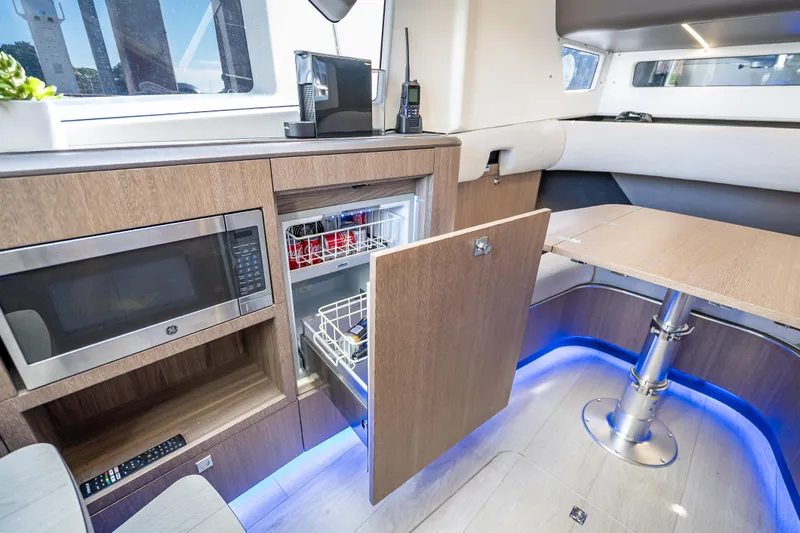  Yacht Photos Pics Modern interior of 2023 Galeon 375 GTO yacht with kitchenette and seating area.