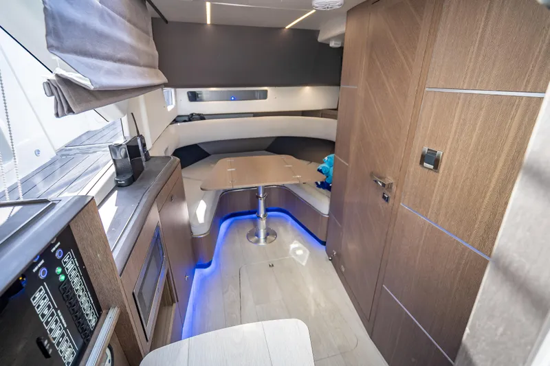  Yacht Photos Pics Luxurious interior of 2023 Galeon 375 GTO yacht with modern wood finishes and ambient lighting.