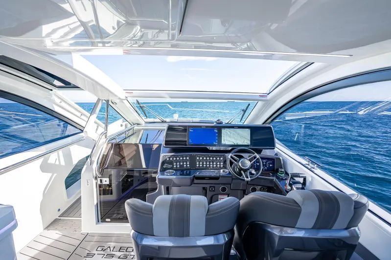  Yacht Photos Pics Interior view of 2023 Galeon 375 GTO yacht cockpit with ocean backdrop.