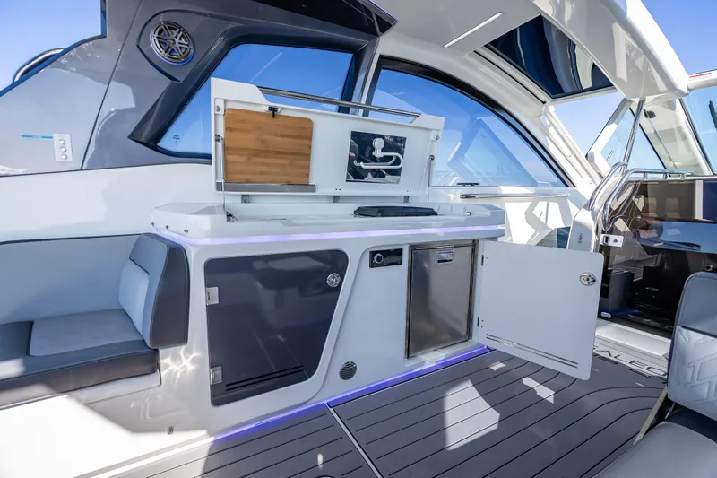  Yacht Photos Pics 2023 Galeon 375 GTO yacht interior with modern kitchenette and seating area.
