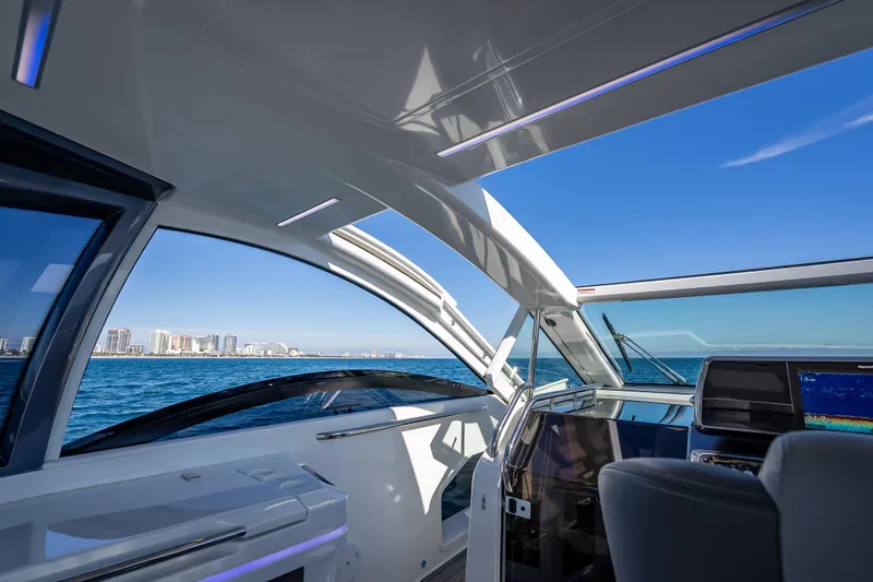  Yacht Photos Pics Interior view of 2023 Galeon 375 GTO yacht with ocean and city skyline.
