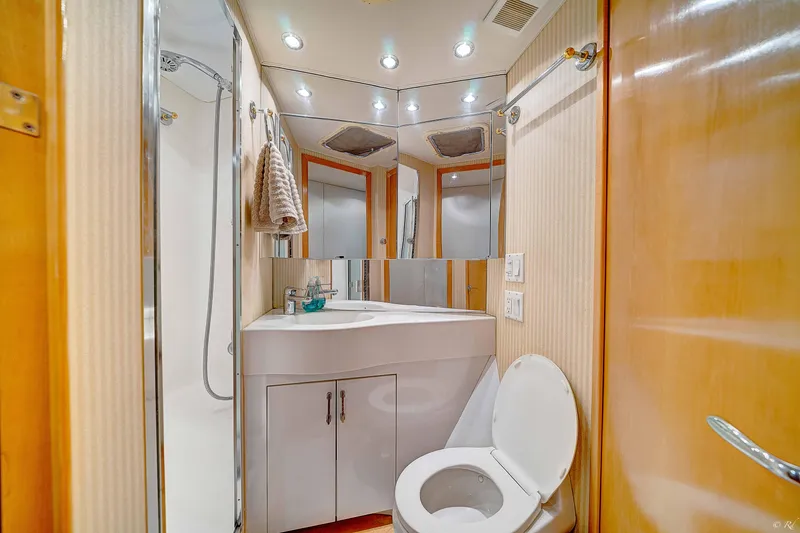  Yacht Photos Pics 1998 Hatteras 60 Convertible yacht bathroom with modern fixtures and ample lighting.