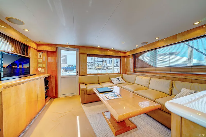  Yacht Photos Pics Luxurious interior of a 1998 Hatteras 60 Convertible yacht with beige seating and wooden accents.