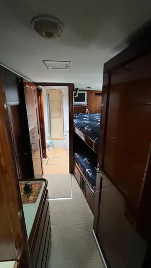 Sea Owl Yacht Photos Pics 1987 Hatteras Motoryacht interior with wooden finish and bunk beds.