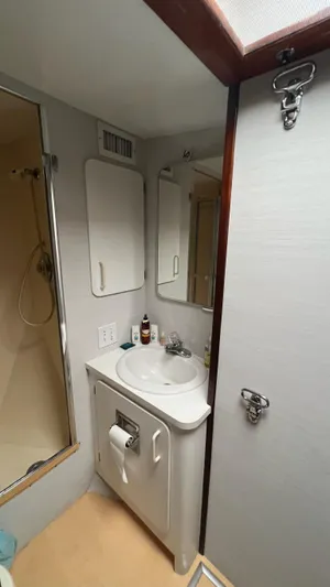 Sea Owl Yacht Photos Pics 1987 Hatteras Motoryacht bathroom with sink, mirror, and shower.