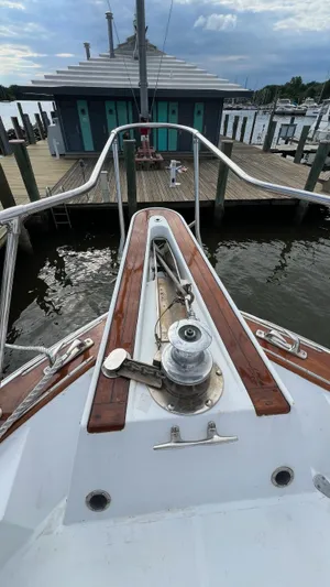 Sea Owl Yacht Photos Pics 1987 Hatteras Motoryacht bow view at dock, featuring wooden deck and winch.