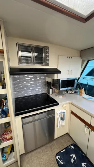 Sea Owl Yacht Photos Pics 1987 Hatteras Motoryacht kitchen with modern appliances and nautical decor.