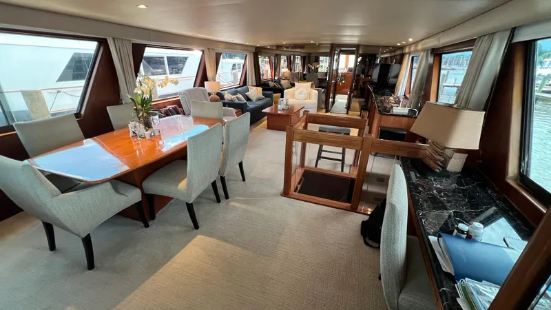 Sea Owl Yacht Photos Pics Luxurious interior of a 1987 Hatteras Motoryacht with elegant dining and seating areas.