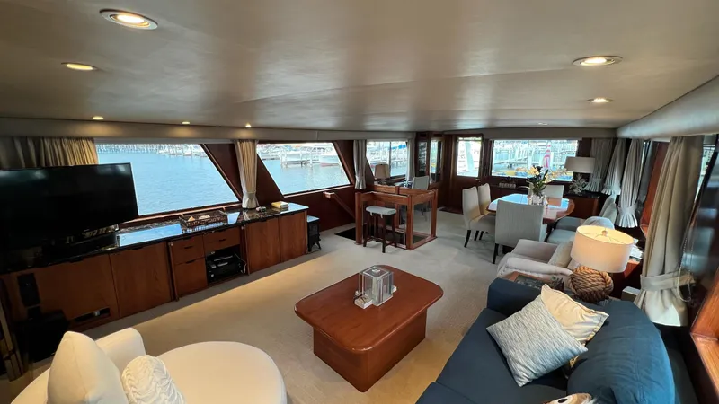 Sea Owl Yacht Photos Pics Luxurious interior of a 1987 Hatteras Motoryacht with elegant furnishings and panoramic windows.