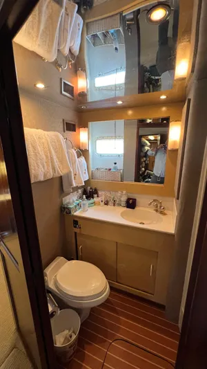 Sea Owl Yacht Photos Pics Bathroom interior of a 1987 Hatteras Motoryacht with modern amenities and wooden flooring.