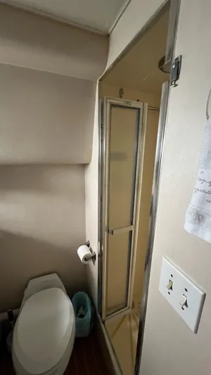 Sea Owl Yacht Photos Pics Bathroom interior of a 1987 Hatteras Motoryacht with shower and toilet.