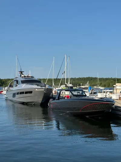 Incognito Yacht Photos Pics 2022 Cigarette 42 Nighteagle yacht docked in a marina under clear blue sky.