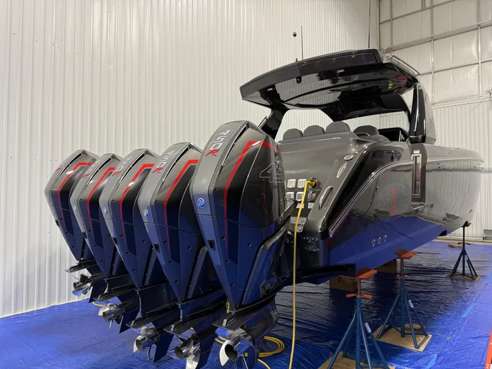 Incognito Yacht Photos Pics 2022 Cigarette 42 Nighteagle boat with multiple outboard engines in a storage facility.