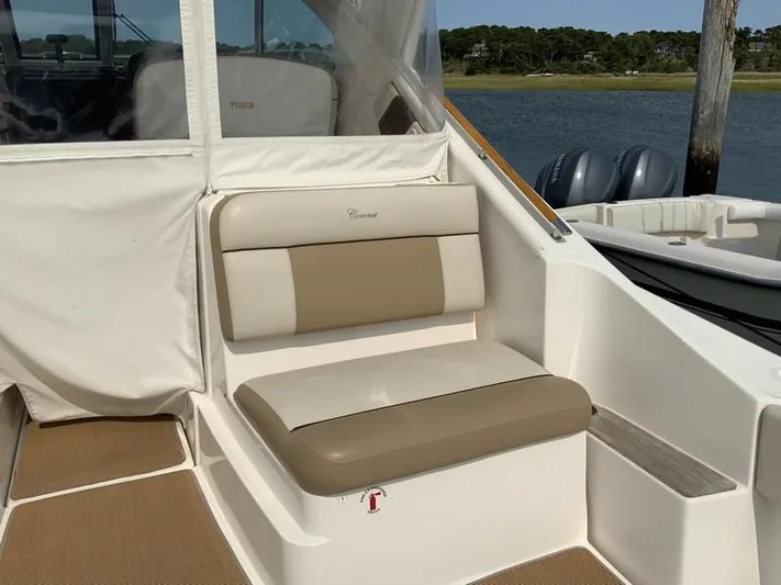 Intuition Yacht Photos Pics 2013 Tiara Yachts 36 interior seating with beige cushions, docked by the water.