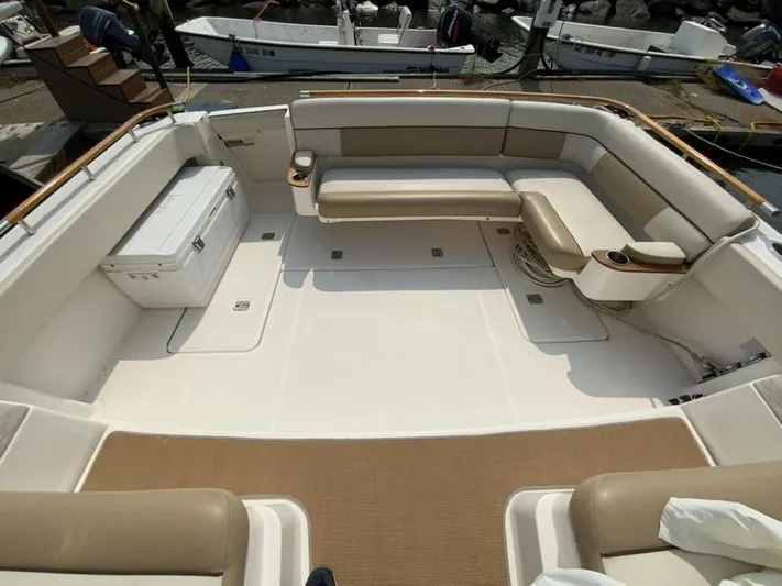 Intuition Yacht Photos Pics Spacious deck of 2013 Tiara Yachts 36 with beige seating and storage.
