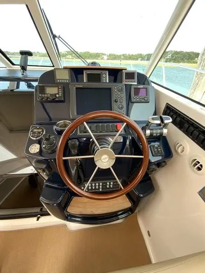 Intuition Yacht Photos Pics Tiara Yachts 36 helm, 2013 model, featuring advanced navigation controls and wooden steering wheel.