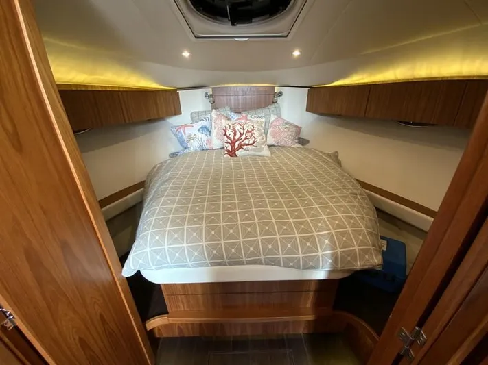 Intuition Yacht Photos Pics Luxurious cabin interior of 2013 Tiara Yachts 36 with cozy bedding and wood accents.