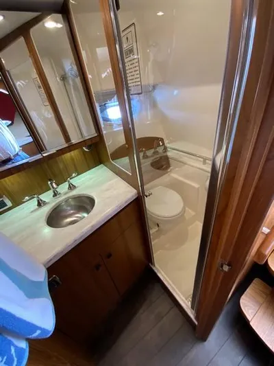 Intuition Yacht Photos Pics 2013 Tiara Yachts 36 bathroom with sink, shower, and wooden cabinetry.