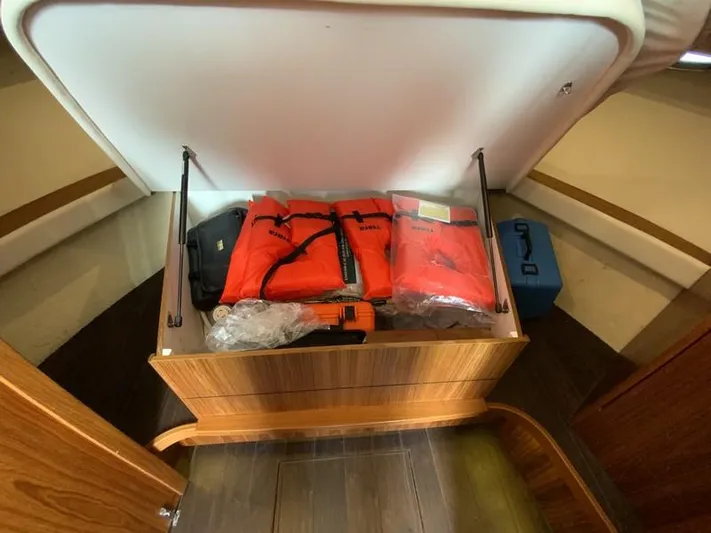 Intuition Yacht Photos Pics Storage compartment in 2013 Tiara Yachts 36, containing life jackets and safety equipment.