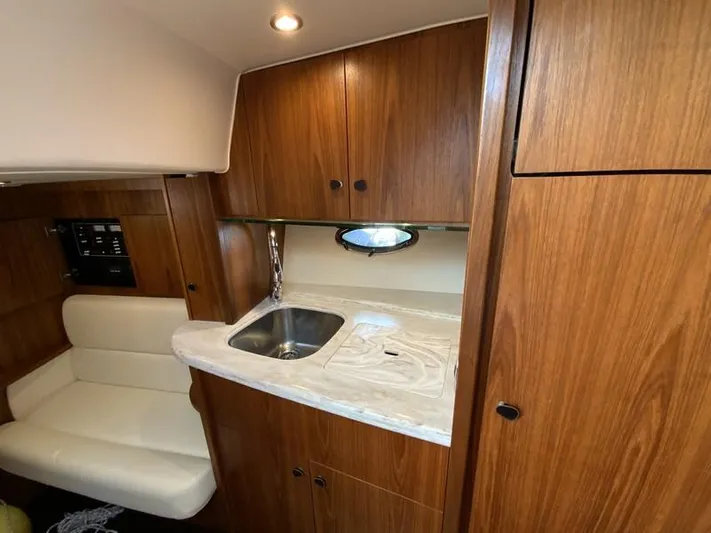 Intuition Yacht Photos Pics 2013 Tiara Yachts 36 interior with wooden cabinetry and compact kitchenette.