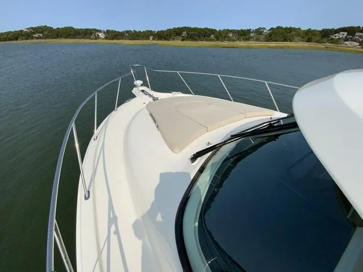 Intuition Yacht Photos Pics Tiara Yachts 36, 2013 model, cruising on calm waters with scenic shoreline view.